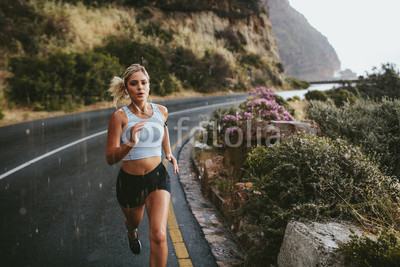 Fitness woman running on highway