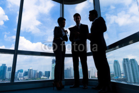 Fototapety Businesspeople standing at office windo working