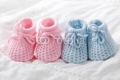 Blue and pink baby booties on white background