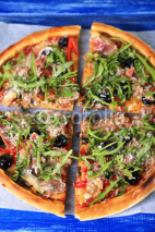 Naklejki Pizza with arugula on color wooden background