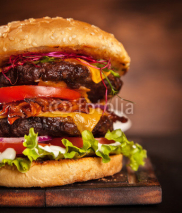 Obrazy i plakaty Fresh home-made hamburger served on wood