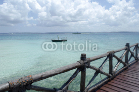 Fototapety Wooden boat on turquoise water in Zanzibar, Tanzania, Africa