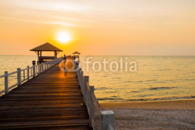 Fototapety The wooden bridge on sea at sunset, Thailand.
