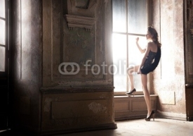 Naklejki Sexy woman posing next to window