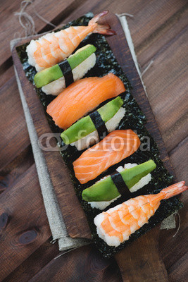 Above view of a sushi set, rustic wooden background