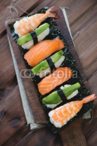 Naklejki Above view of a sushi set, rustic wooden background
