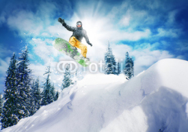 Fototapety Snowboarder jump against sky and trees