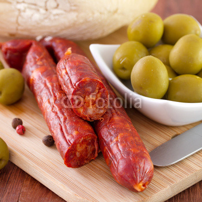 sausages with olives in bowl