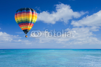 Colorful hot air balloon fly over the blue sea