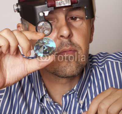 jeweler looking in a sapphire