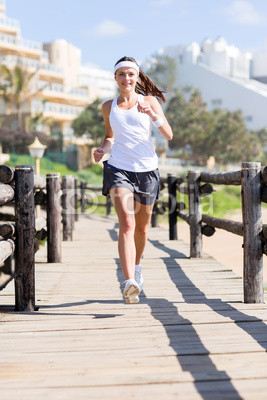 young woman jogging at the beach