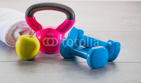 weight lifting and weight loss concept with apple and towel
