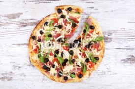 Fototapety Pizza on white wooden background.