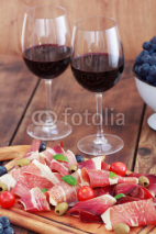 Naklejki sliced prosciutto with red wine and olives