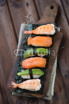Fototapety Sushi set on a rustic wooden background, studio shot