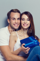 smiling couple with blue gift box