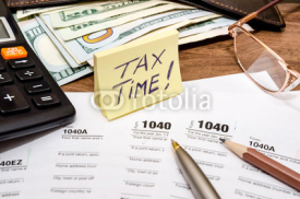 Obrazy i plakaty Tax time concept with 1040 tax document and money