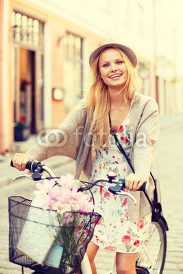 attractive woman in hat with bicycle in the city