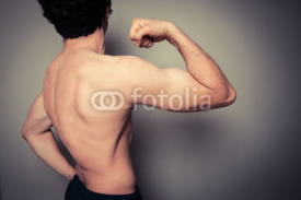 Fototapety Rear view of athletic young man