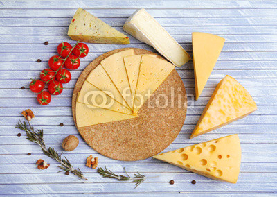 Different Italian cheese on wooden table