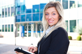 Naklejki Successful businesswoman with tablet