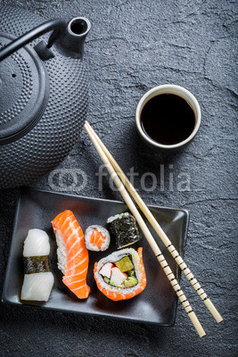 Fresh sushi served in a black ceramic