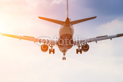 Commercial airplane taking off at sunrise