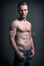 Naklejki Healthy good looking young muscled fitness man wearing blue jean