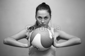 Naklejki Young athlete woman holding a ball