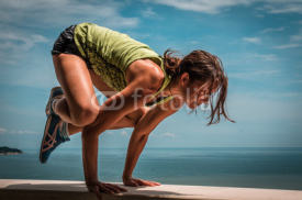 Naklejki Young woman doing pose arm balance