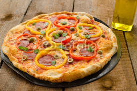 Fototapety Italian pizza with paprika, salami and olives