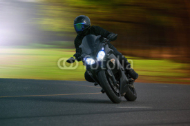 Obrazy i plakaty young man riding big bike motorcycle on asphalt high way against