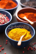 Obrazy i plakaty spices in bowls: curry, pink and black pepper, paprika powder