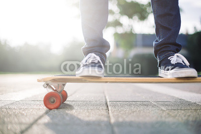 Skater in sneakers on skateboard