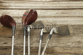 Fototapety Old golf clubs on rough wood surface