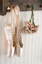 Fototapety Pair of ballet pointe shoes hanging from a rack