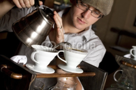 Naklejki a coffee house employee brew a single cup of coffee