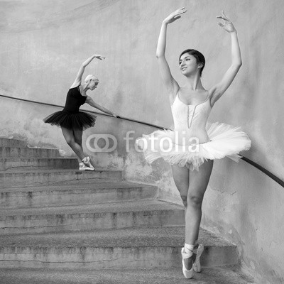Young beautiful dancers along the stairs. Black and white image.