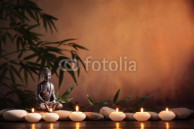 Naklejki Buddha with burning candle and bamboo