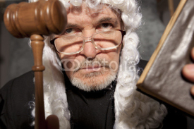 Senior judge in a courtroom striking the gavel