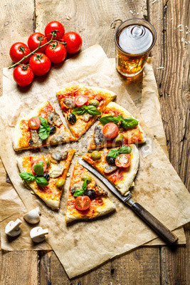 Freshly baked pizza served with a cold drink
