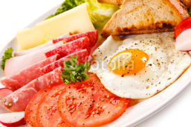 Breakfast - toasts, fried egg and sausages, cheese, ham and vegetables 