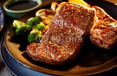 Marinated seasoned meat with broccoli in plate