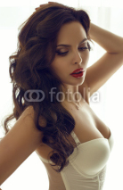 Fototapety beautiful woman in lingerie posing beside a window