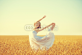 Naklejki happy young woman enjoying life in golden wheat field