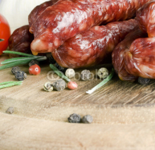 Naklejki Smoked sausage with rosemary and peppercorns