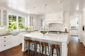 Beautiful White Kitchen in New Luxury Home with Lights On