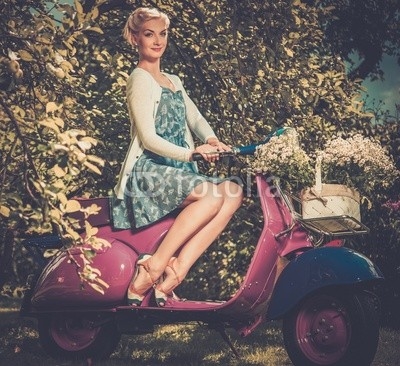 Beautiful blond woman sitting on a retro roller