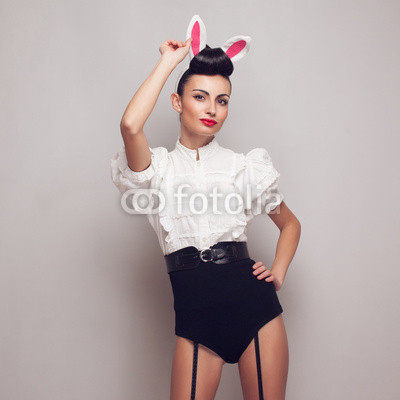 Sexy pinup model posing in vintage bunny costume