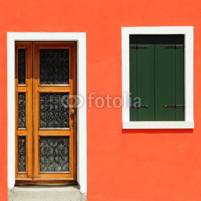 front door in vivid  orange painted house in Burano village
